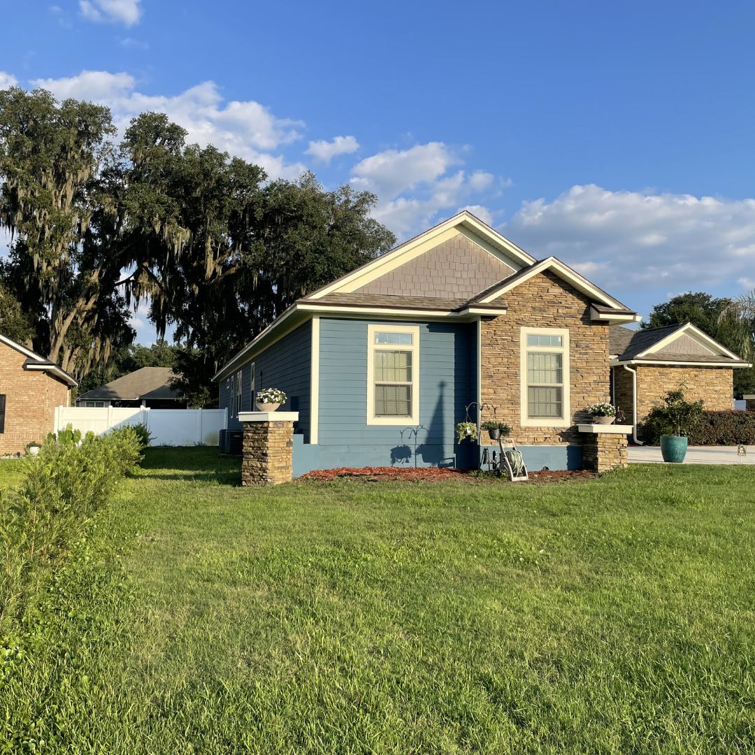 Exterior blue craftsman home with stone accent