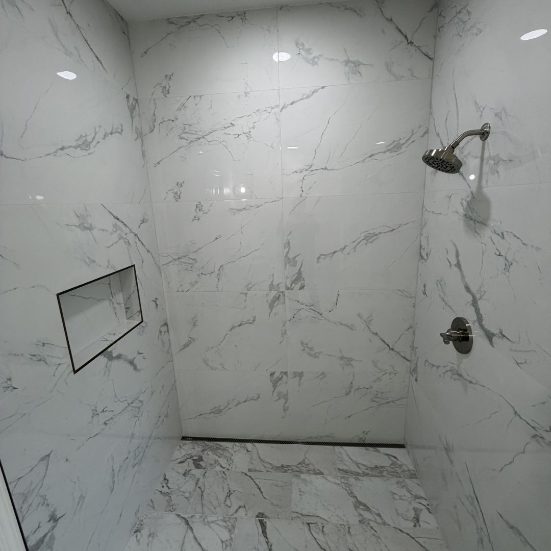 Walk-in marble shower with niche