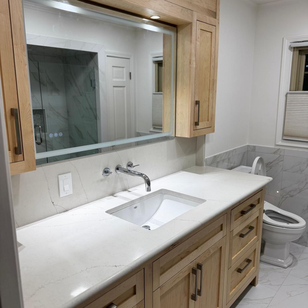 Bathroom vanity with maple cabinets and quartz countertop
