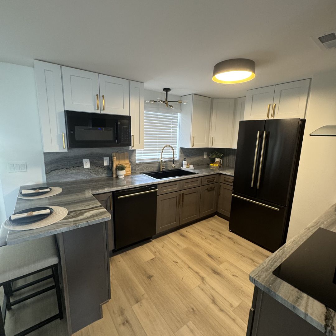 Modern kitchen with white cabinets and stone countertops
