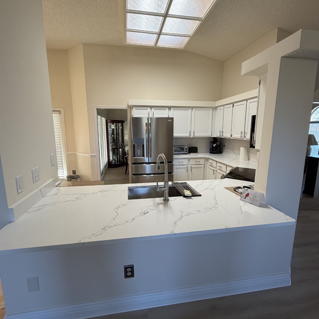 Kitchen with vaulted ceiling and quartz waterfall